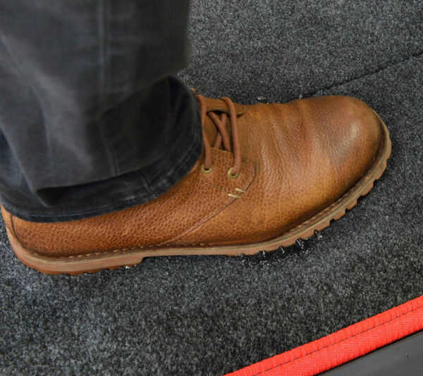 Sanistride shoe disinfecting mat insert that dispenses sanitizer added by customer to bottom of shoes thoroughly saturating treads